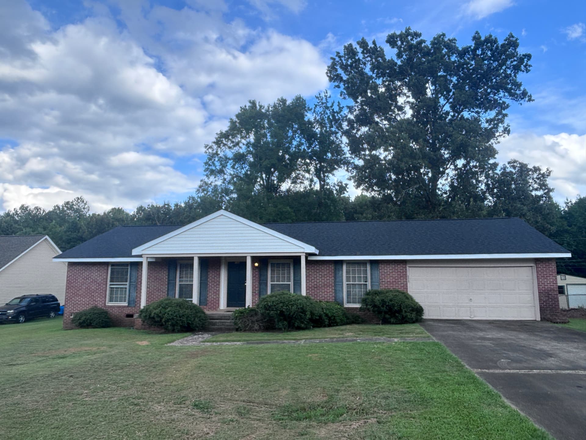 Brick ranch home in Greenwood SC with a new dark architectural shingle roof by Coster Roofing Co